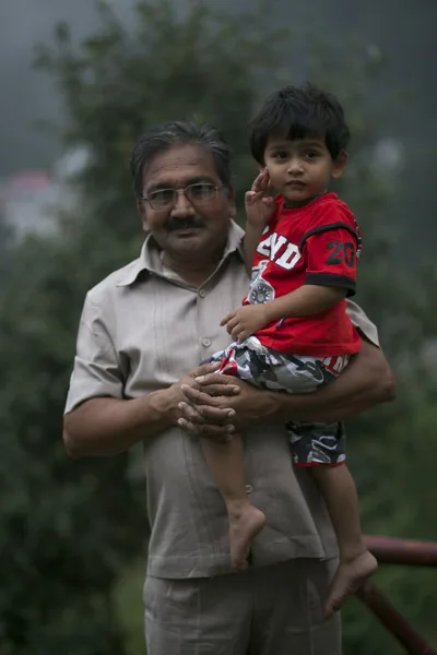 Guruji Maharaj holding a young child