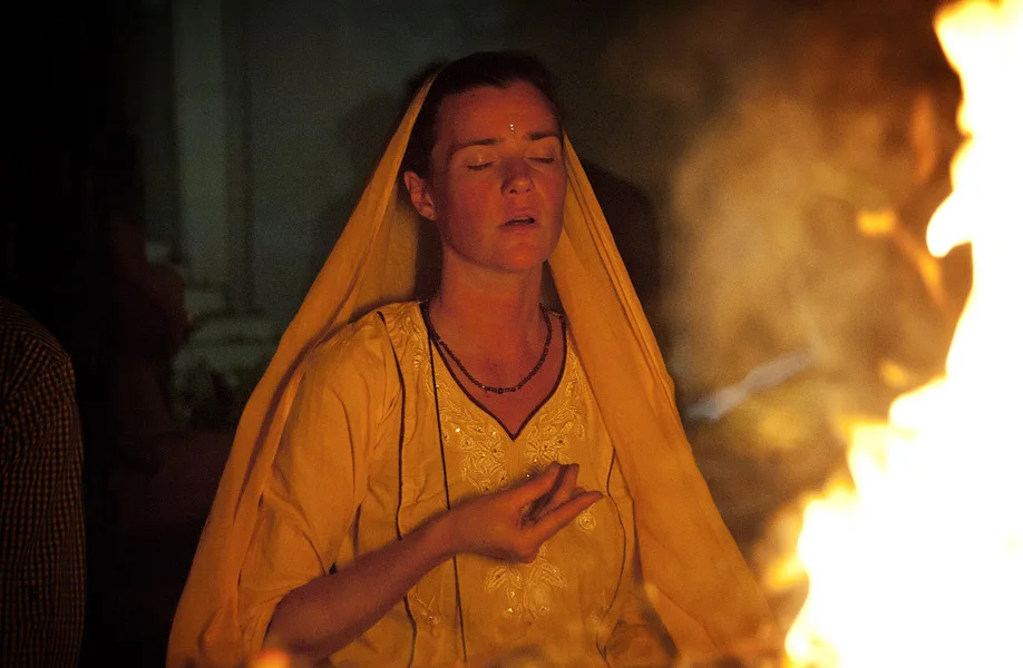 A practitioner in meditation beside the sacred fire